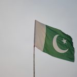 green and white flag under white sky during daytime