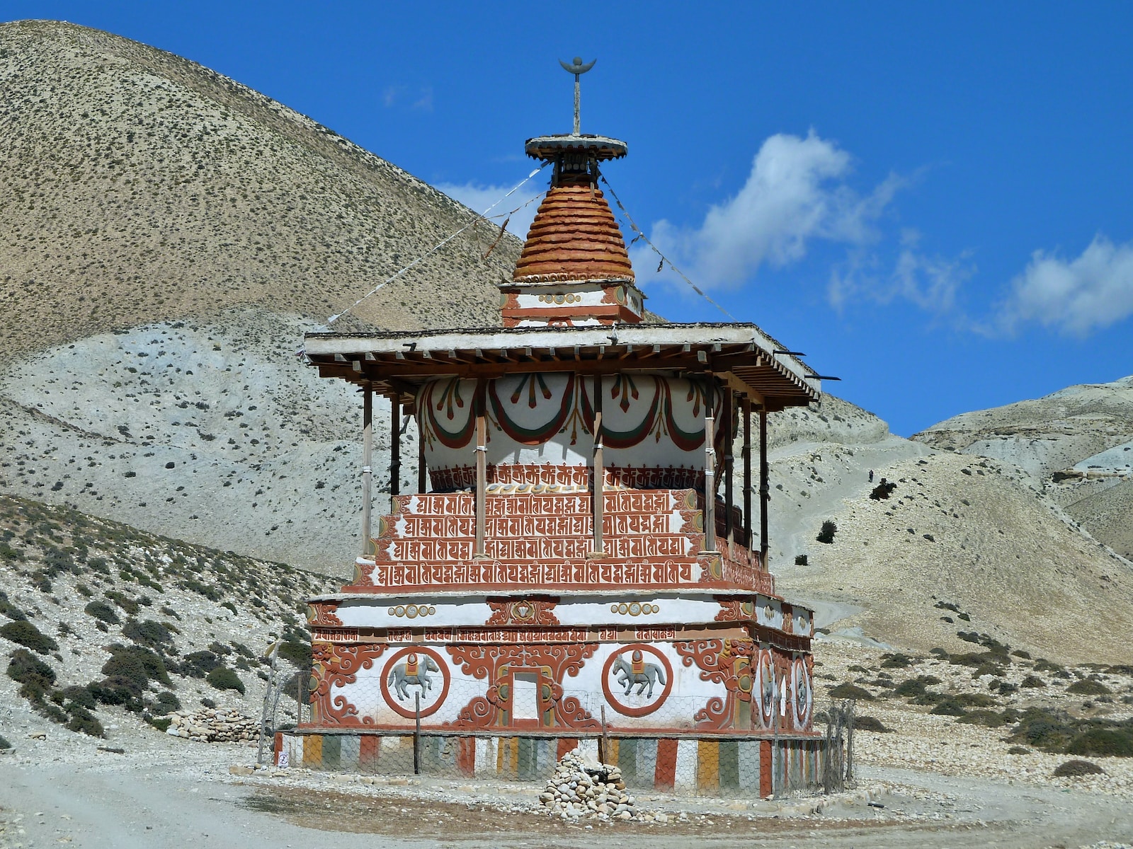 red and yellow temple near mountain under blue sky during daytime