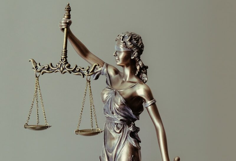 woman in gold dress holding sword figurine